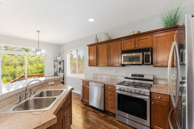 9050 SW 161st Ave, Beaverton, OR 97007 - kitchen with appliances with stainless steel finishes, a sink, tile counters, dark wood-style floors, and recessed lighting