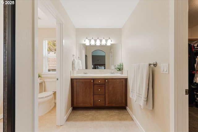 9050 SW 161st Ave, Beaverton, OR 97007 - full bath featuring toilet, double vanity, baseboards, and a walk in closet