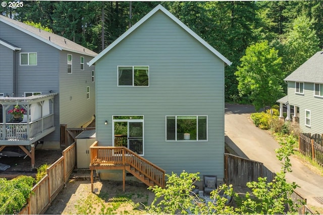 9050 SW 161st Ave, Beaverton, OR 97007 - back of house featuring a wooden deck, a fenced backyard, and stairway