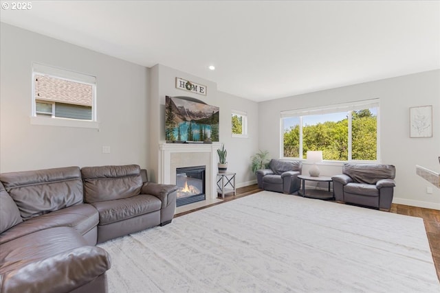 9050 SW 161st Ave, Beaverton, OR 97007 - living area featuring dark wood-style flooring, a fireplace with flush hearth, baseboards, and recessed lighting