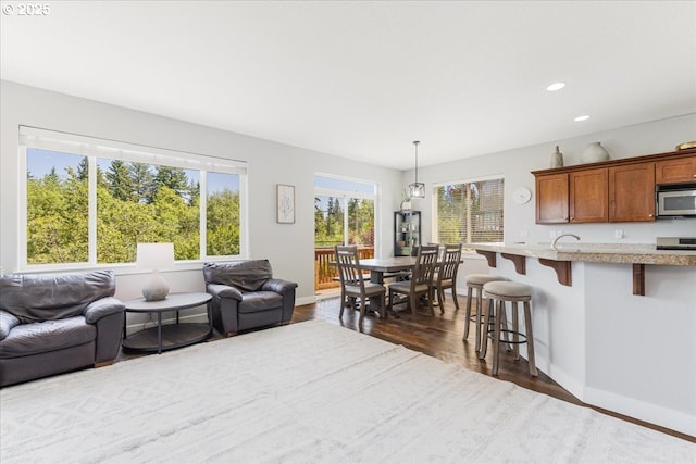 9050 SW 161st Ave, Beaverton, OR 97007 - living area with dark wood-type flooring, baseboards, and recessed lighting