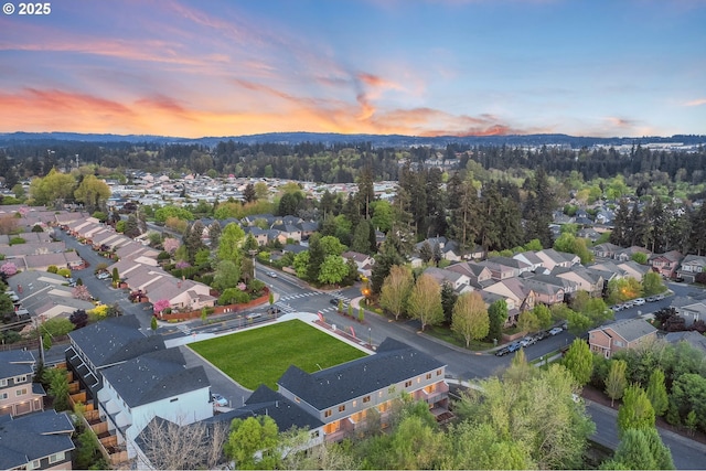aerial view at dusk featuring a residential view