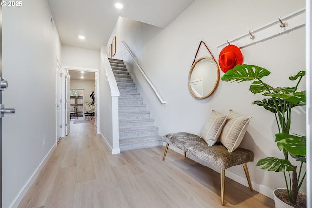 entrance foyer with stairs, recessed lighting, baseboards, and light wood-type flooring