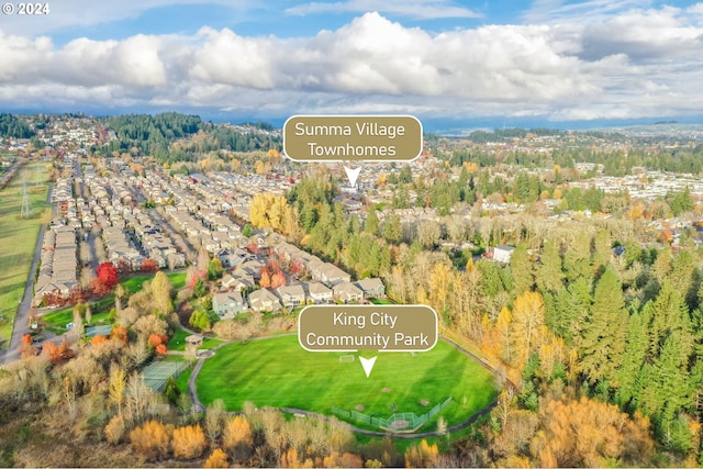 aerial view featuring a residential view and a wooded view