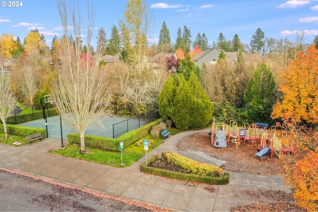 exterior space featuring fence, playground community, and a tennis court