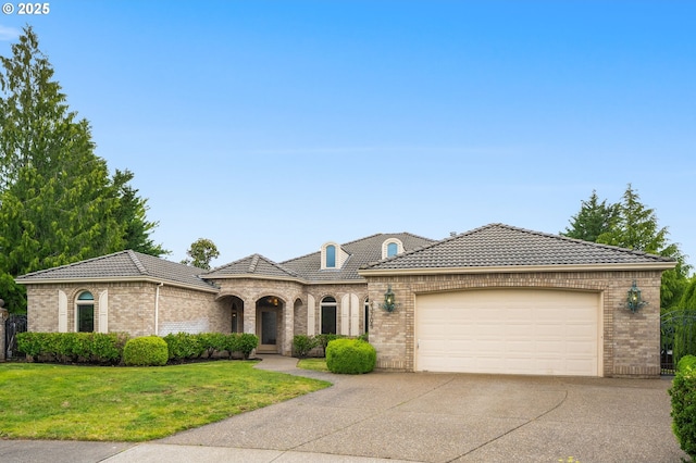 23705 SW Everest Ct, Sherwood, OR 97140 - french country style house with brick siding, driveway, a garage, a front yard, and a tiled roof