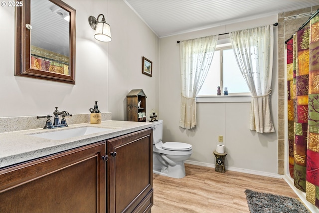 full bathroom with wood finished floors, toilet, curtained shower, vanity, and crown molding