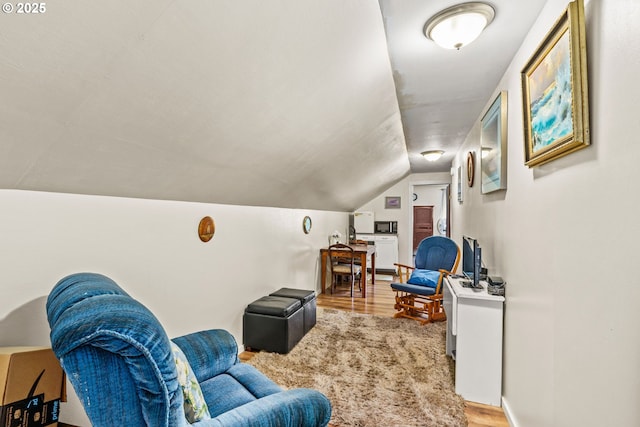 living room featuring light wood-style flooring and lofted ceiling