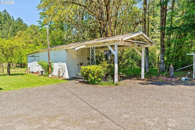 exterior space with a carport and dirt driveway