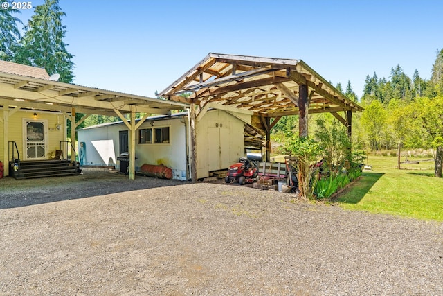 exterior space with gravel driveway and a detached carport