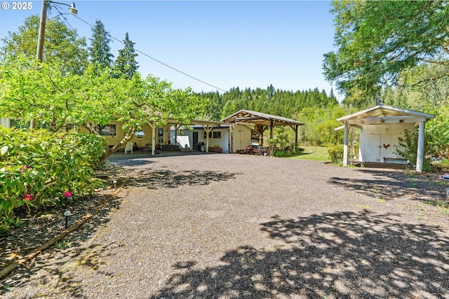 view of front of house featuring a detached carport and driveway