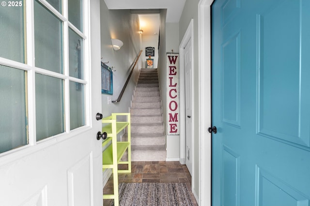 entrance foyer with stone finish floor and stairs