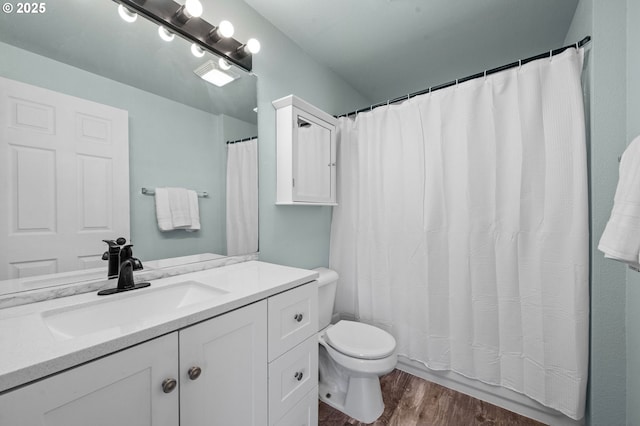 full bathroom with toilet, vanity, a shower with curtain, and wood finished floors