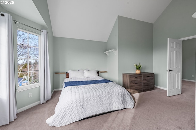 carpeted bedroom with multiple windows, lofted ceiling, and baseboards