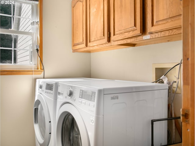 clothes washing area with cabinet space and washing machine and clothes dryer