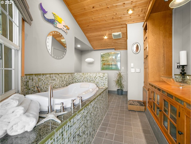 full bathroom featuring tile patterned flooring, wooden ceiling, a bath, and lofted ceiling