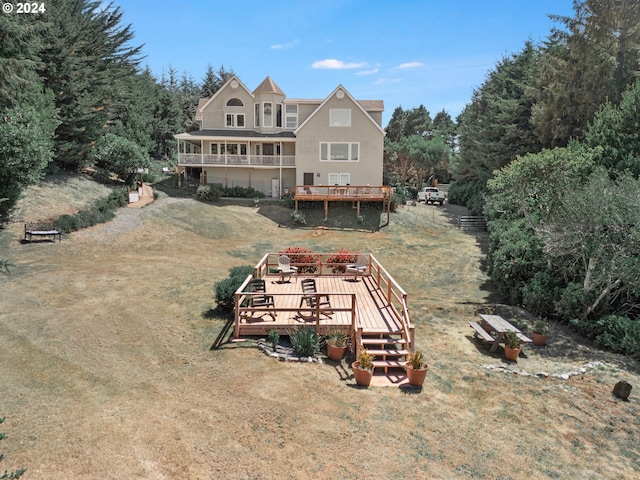 back of house featuring a wooden deck