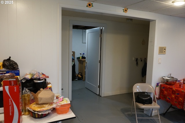 interior space featuring concrete flooring and a drop ceiling