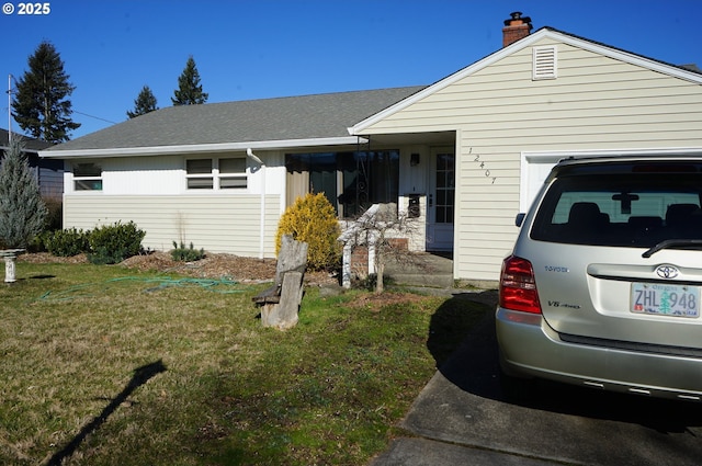 single story home featuring a garage and a front yard