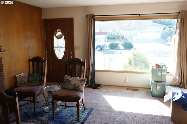 carpeted foyer with a healthy amount of sunlight