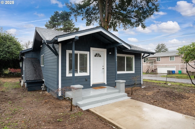 10304 SE Yukon St, Portland, OR 97266 - view of front facade featuring a gate, a shingled roof, and a fenced front yard