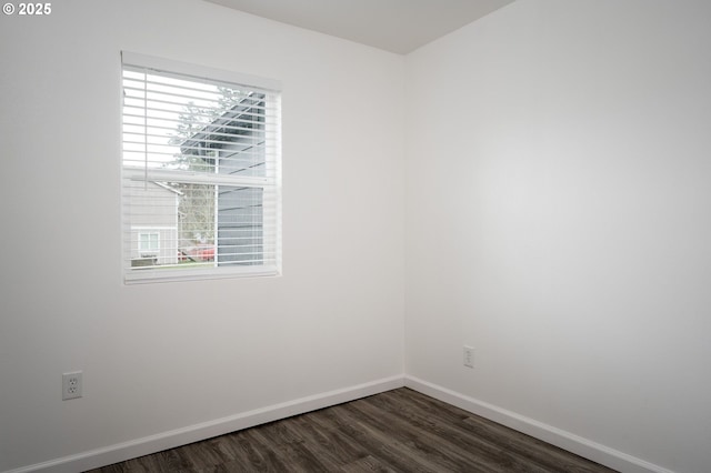 spare room featuring dark hardwood / wood-style flooring