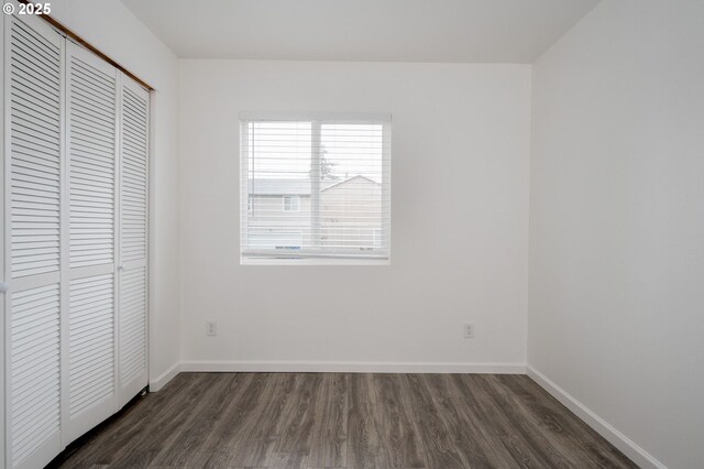 10304 SE Yukon St, Portland, OR 97266 - unfurnished bedroom with dark wood-style floors, a closet, and baseboards