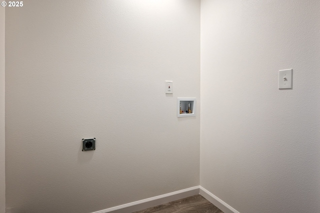 clothes washing area with electric dryer hookup, washer hookup, and dark hardwood / wood-style flooring