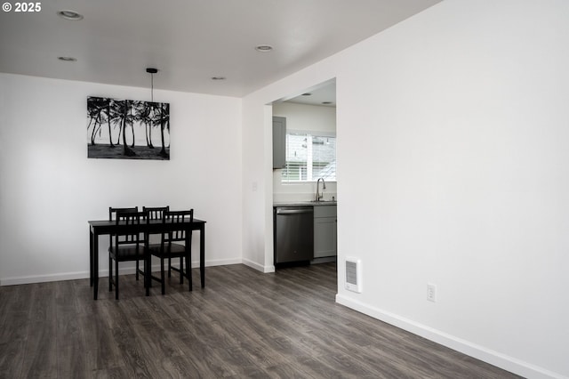 dining area with sink and dark hardwood / wood-style flooring