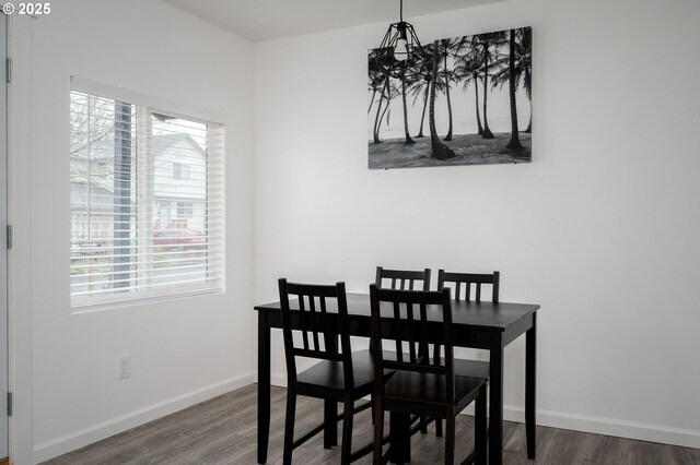10304 SE Yukon St, Portland, OR 97266 - dining area with a chandelier, healthy amount of natural light, dark wood finished floors, and baseboards