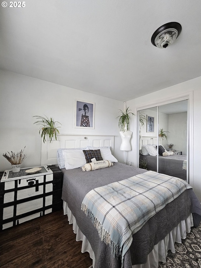 bedroom featuring a closet and dark hardwood / wood-style floors