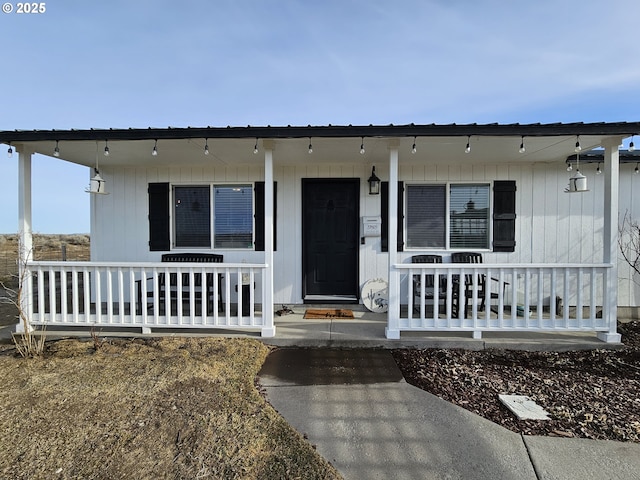 view of exterior entry with a porch