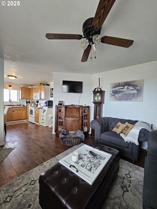 living room with dark hardwood / wood-style flooring and ceiling fan