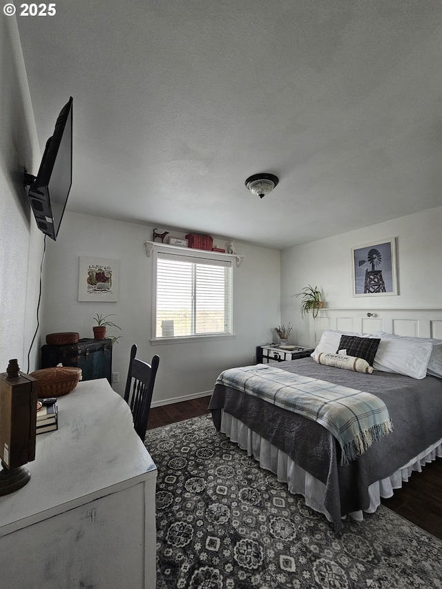 bedroom with dark hardwood / wood-style flooring