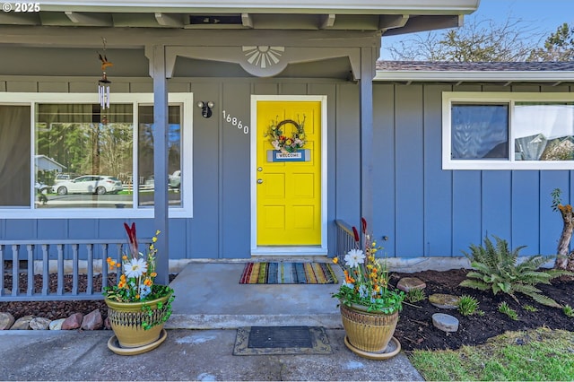 doorway to property featuring a porch and board and batten siding