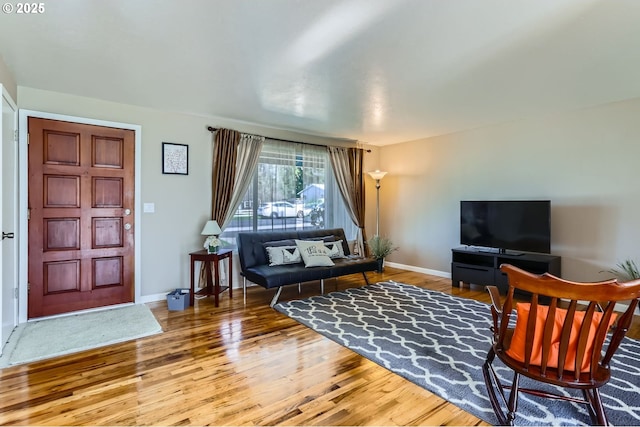 living room with baseboards and wood-type flooring