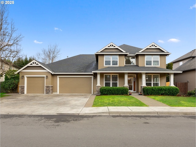 craftsman-style home with a garage and a front lawn