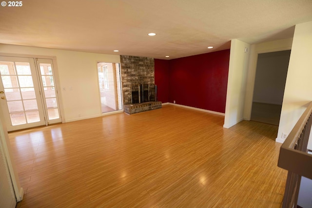 3663 Wilshire Ln, Eugene, OR 97405 - unfurnished living room featuring light wood-style flooring, a brick fireplace, baseboards, and recessed lighting