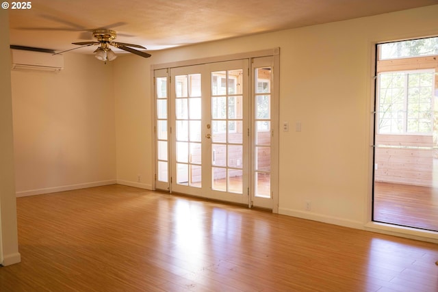 3663 Wilshire Ln, Eugene, OR 97405 - spare room with a ceiling fan, an AC wall unit, wood finished floors, and baseboards