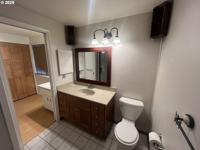 3663 Wilshire Ln, Eugene, OR 97405 - bathroom featuring toilet, tile patterned floors, vanity, and a closet