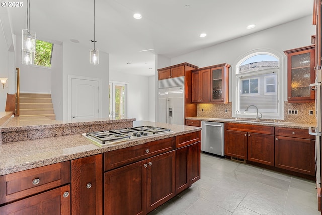 370 NW 81st Pl, Portland, OR 97229 - kitchen featuring appliances with stainless steel finishes, decorative backsplash, decorative light fixtures, light stone counters, and recessed lighting