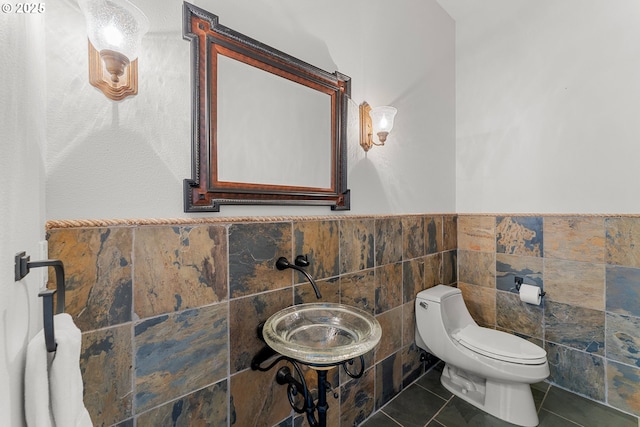 370 NW 81st Pl, Portland, OR 97229 - bathroom with tile walls, toilet, tile patterned flooring, and wainscoting