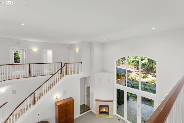 370 NW 81st Pl, Portland, OR 97229 - unfurnished living room with a towering ceiling, recessed lighting, carpet floors, and a glass covered fireplace