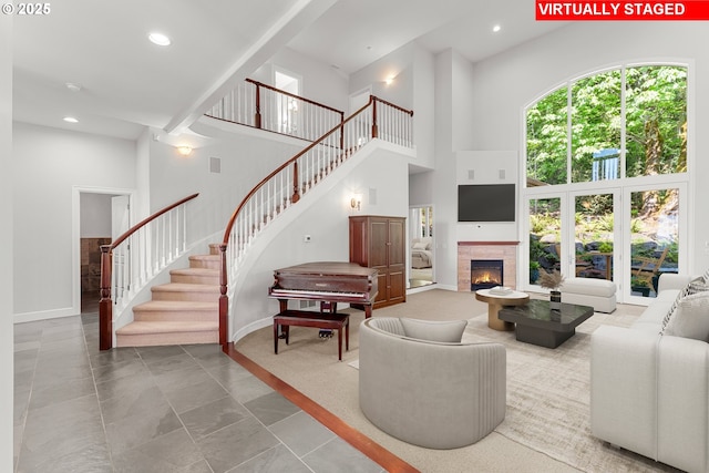 370 NW 81st Pl, Portland, OR 97229 - living room with a towering ceiling, stairway, recessed lighting, a warm lit fireplace, and baseboards