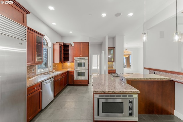 370 NW 81st Pl, Portland, OR 97229 - kitchen featuring built in appliances, a sink, tasteful backsplash, light stone counters, and glass insert cabinets
