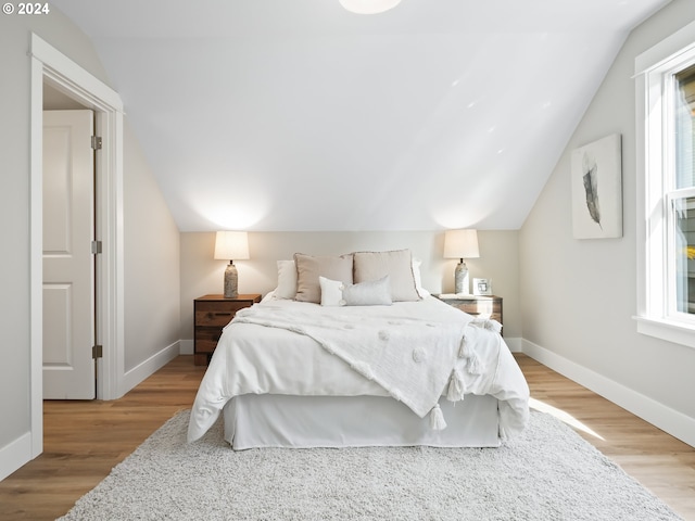 5325 NE Flanders St, Portland, OR 97213 - bedroom featuring vaulted ceiling, wood finished floors, and baseboards