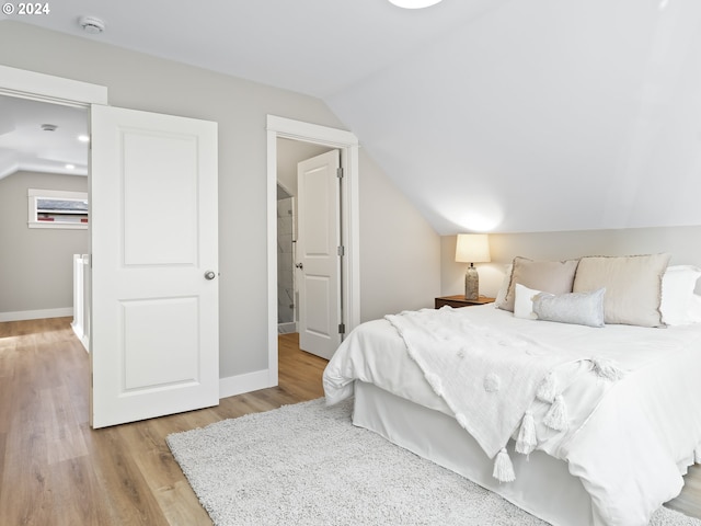 5325 NE Flanders St, Portland, OR 97213 - bedroom featuring lofted ceiling, wood finished floors, and baseboards