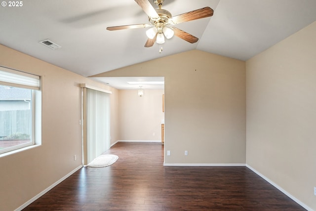 spare room with visible vents, baseboards, dark wood finished floors, lofted ceiling, and a ceiling fan