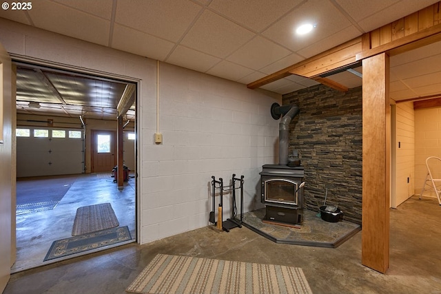 unfurnished living room with a wood stove and concrete floors