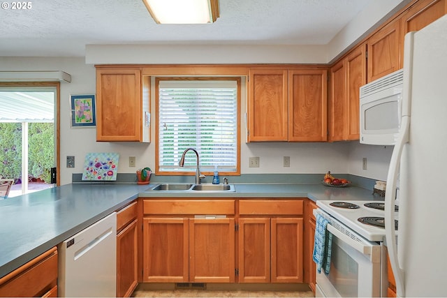 5219 Lacey Ct N, Keizer, OR 97303 - kitchen featuring a sink, a textured ceiling, visible vents, white appliances, and brown cabinets